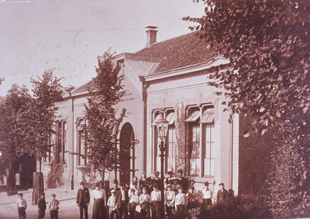 De Paasbergschool in 1906 met enige leerlingen en onderwijzend personeel. Voor de ingang, met bolhoed, Jan Voorink.